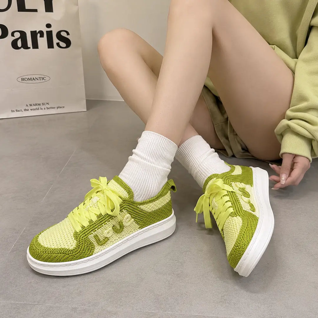 Neon green and cream handmade knit sneakers worn on feet with white socks — artisan crochet custom sneakers
